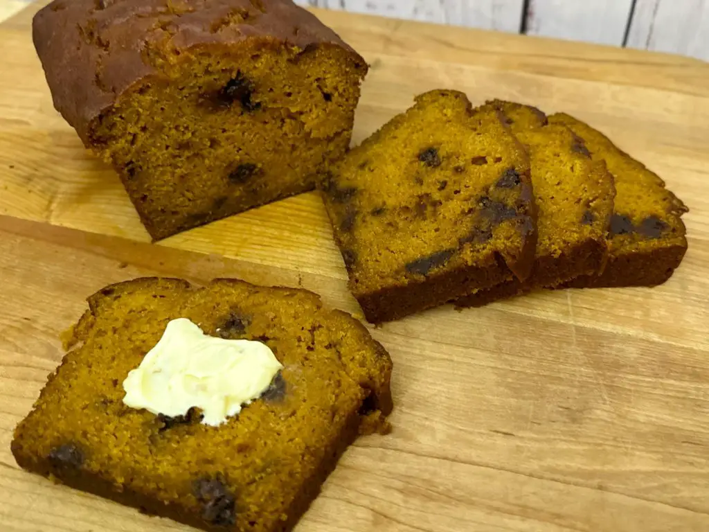 Chocolate Chip Pumpkin Bread loaf and slices, with butter.