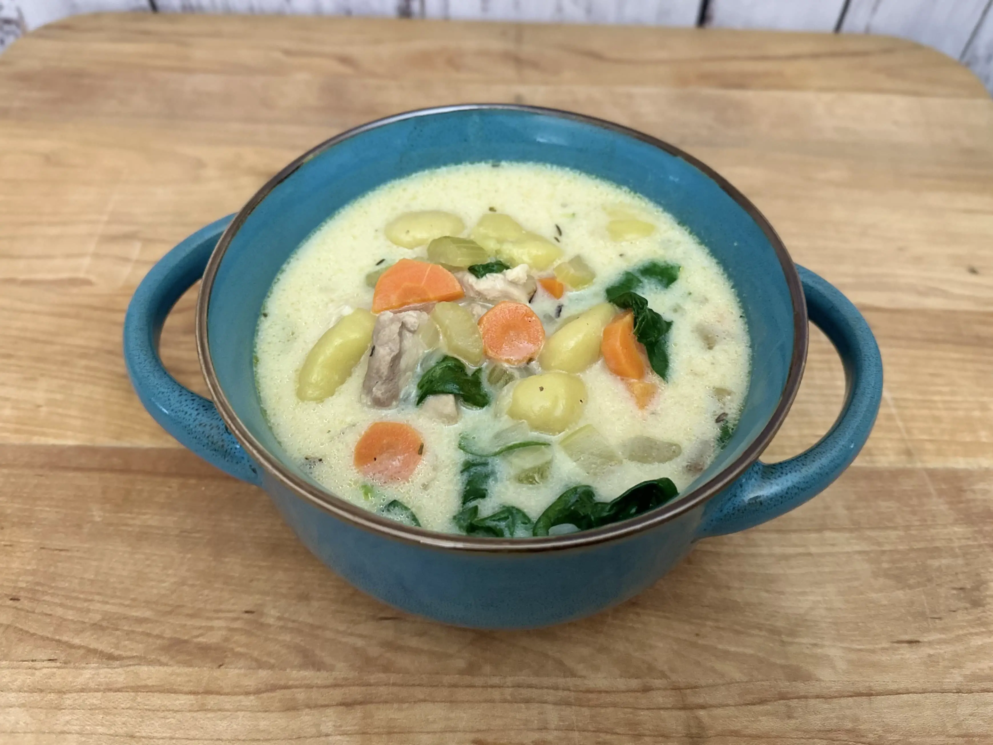 Creamy Chicken Gnocchi Soup in a blue bowl.
