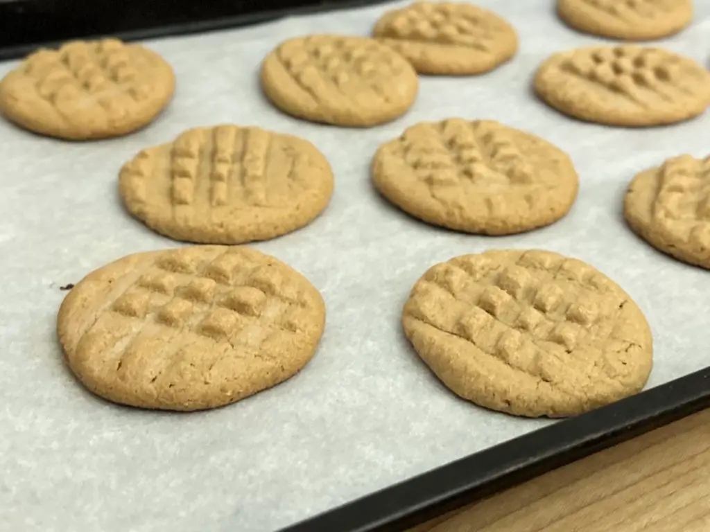 Peanut Butter Cookies on a cooking tray covered in parchment paper.