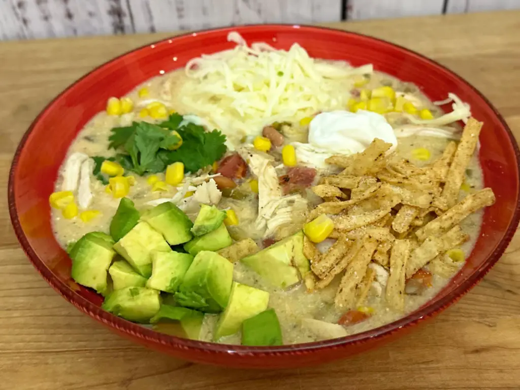 Green Enchilada Chicken Soup in a red bowl.