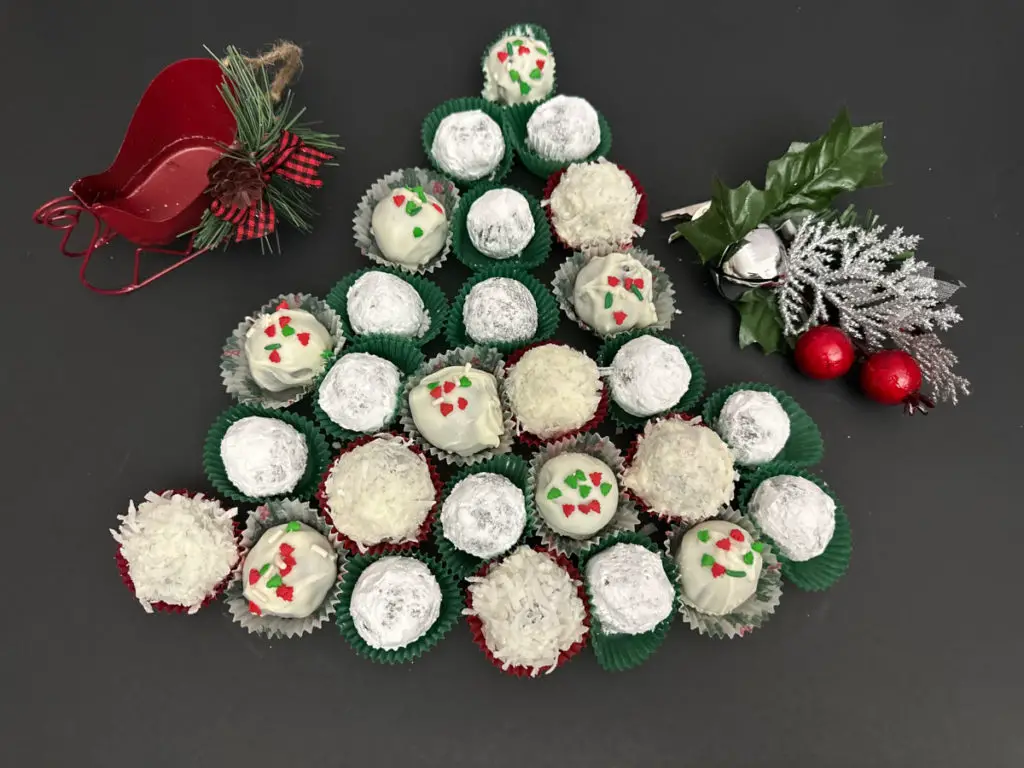 Rum Balls with various toppings arranged in a festive tree shape with holiday decorations.