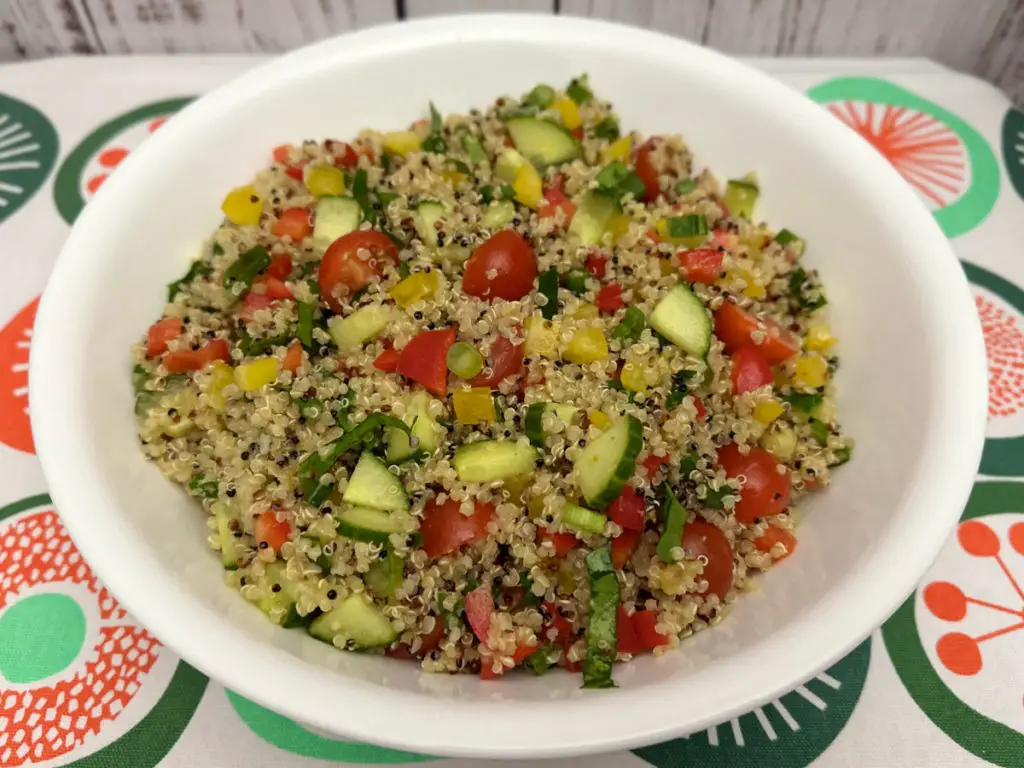 Vegetable Quinoa Salad in a white bowl on a colorful napkin.