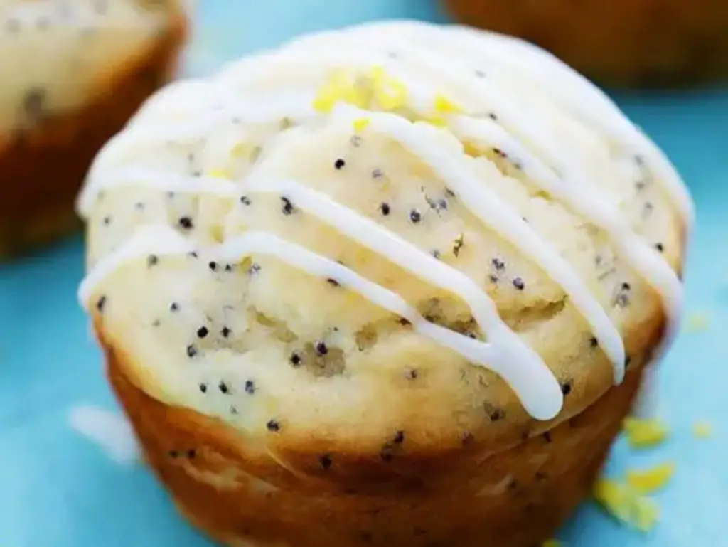 Lemon Poppy Seed Muffin with lemon glaze drizzled over the muffin.